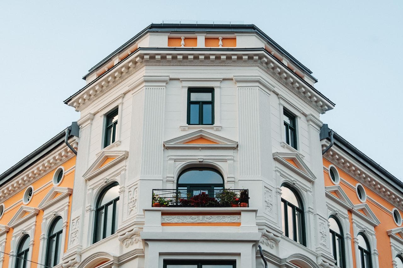 Lys Oslo-bygård med dekorert pussfasade og originale bygningsdetaljer